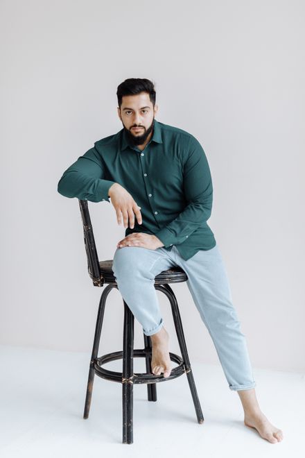 Bearded man in a green shirt in a studio setting — photo by Thirdman on Pexels