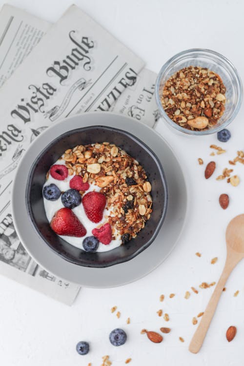 Free Granola with Fruits and Yoghurt in Bowl on Table Stock Photo