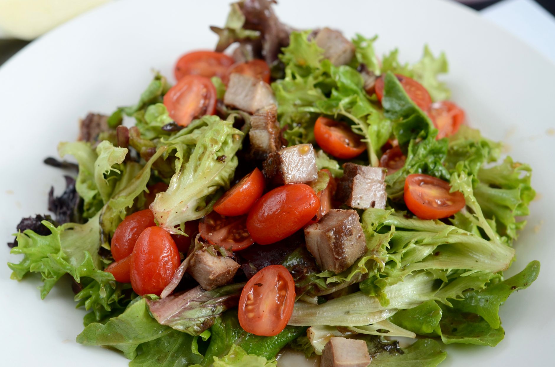 Warm bacon and shallot vinaigrette over fresh greens