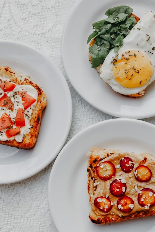 Free Toasted Bread with an Egg, Cream with Tomato and Strawberries  Stock Photo