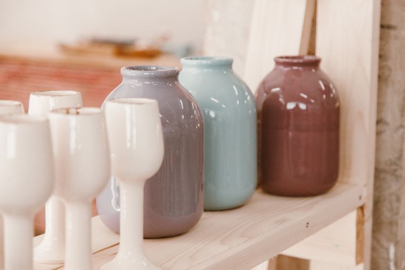 Pastel ceramic vases on a wooden shelf by Roman Odintsov on Pexels