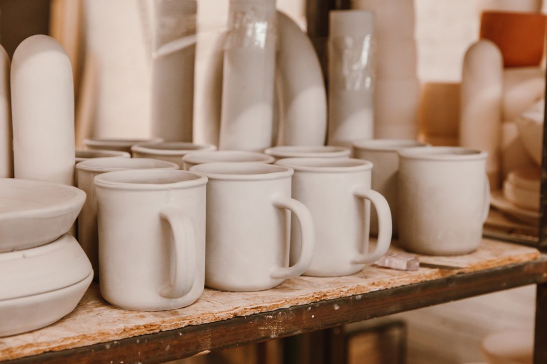 Unglazed ceramic mugs on a studio shelf, photo by ROMAN ODINTSOV on Pexels