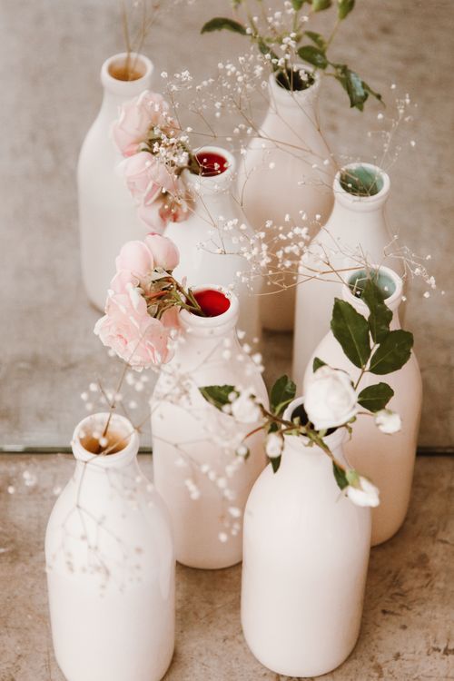 Free Minimalist white vases with pink and white flowers create a serene aesthetic arrangement. Stock Photo