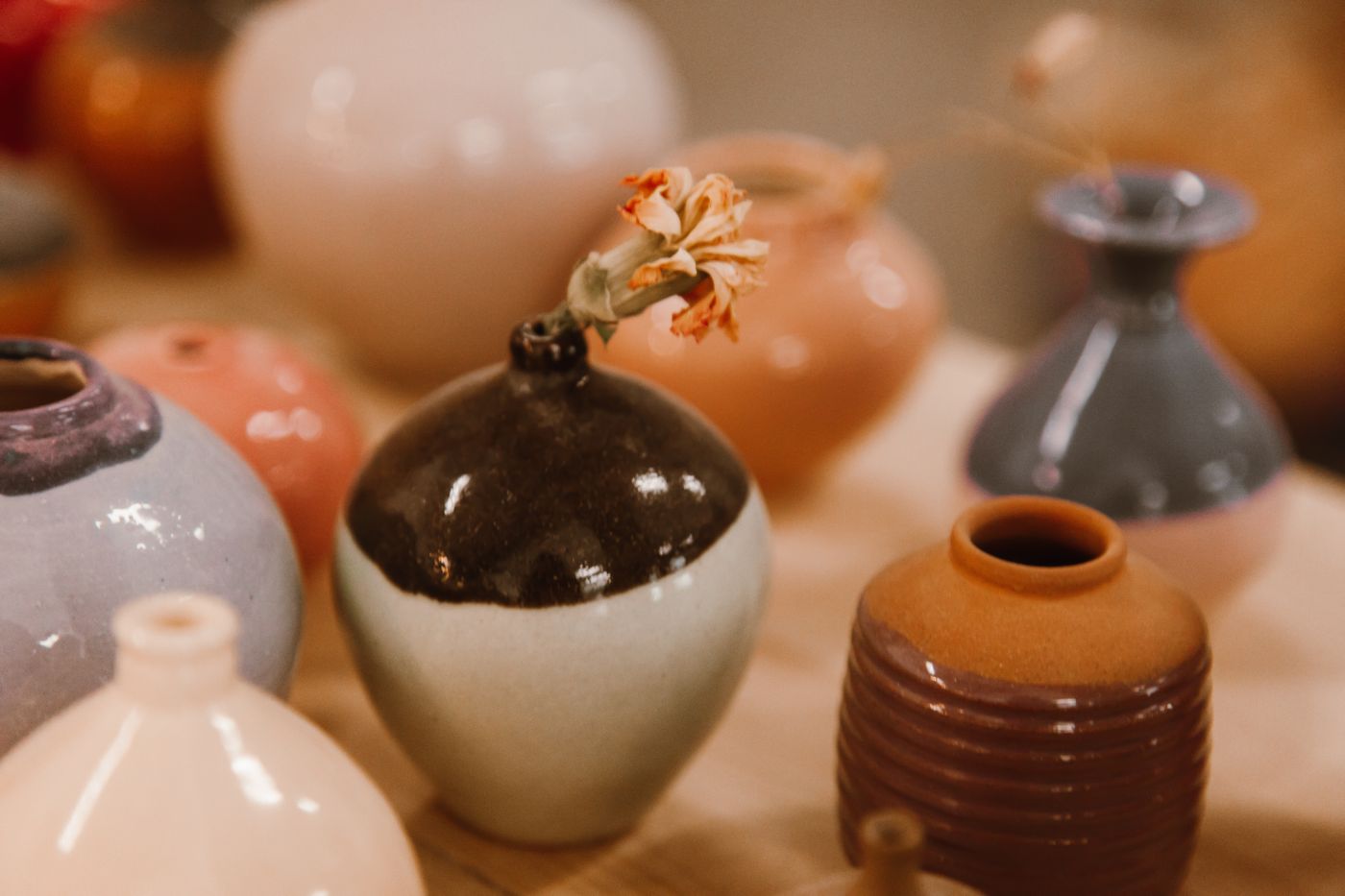 Hand-glazed ceramic vase with softly irregular surface and floral styling