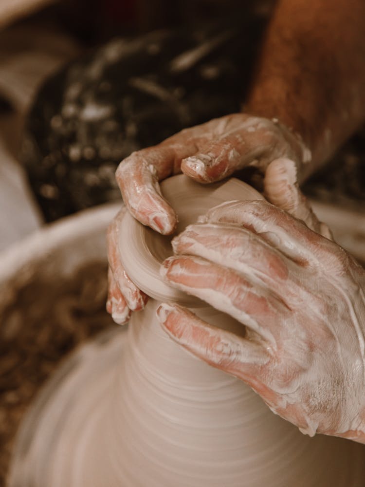 A Person Making A Pot