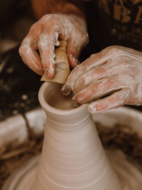 A Person Making Clay Pot With Clay