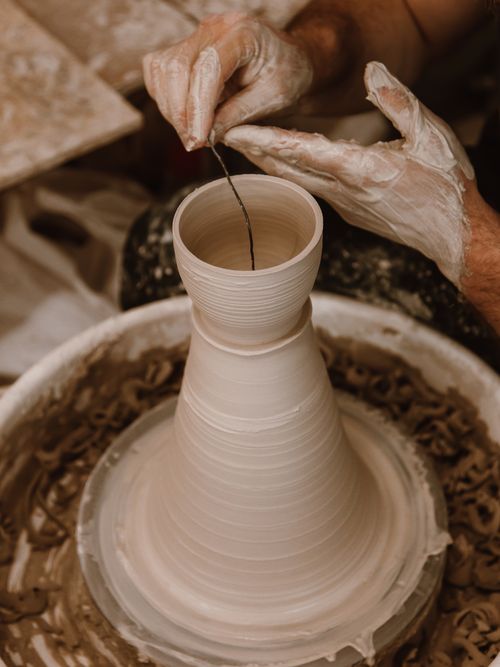 Shaping a clay vase by Roman Odintsov on Pexels