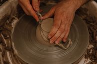 Person Holding Round Brown Wooden Plate