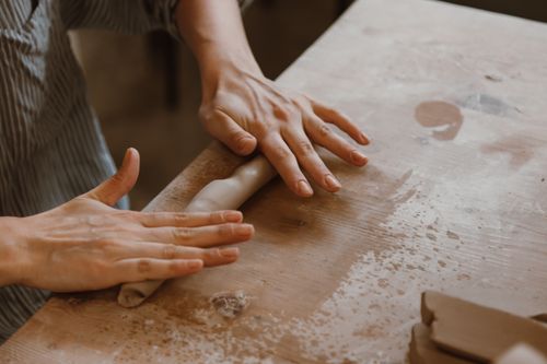 Free Detailed close-up of hands crafting clay on an artisan's table. Stock Photo