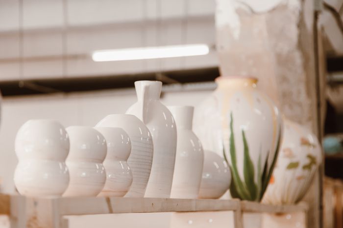 Row of finished ceramic vases displayed on a studio shelf — ROMAN ODINTSOV on Pexels