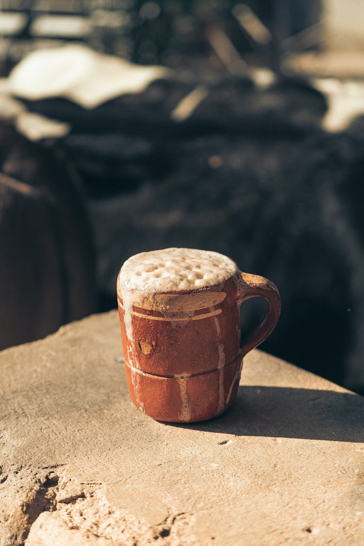 Overflowing White Liquid From Brown Ceramic Mug 