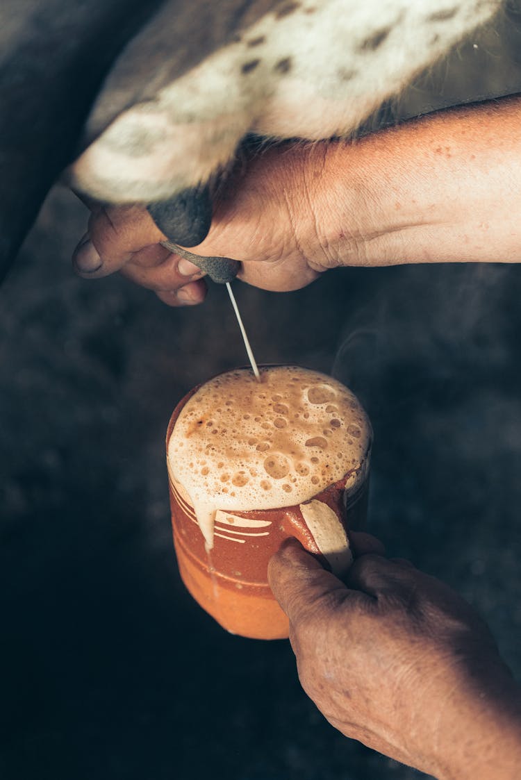 Overflowing Milk In A Brown Ceramic Mug 