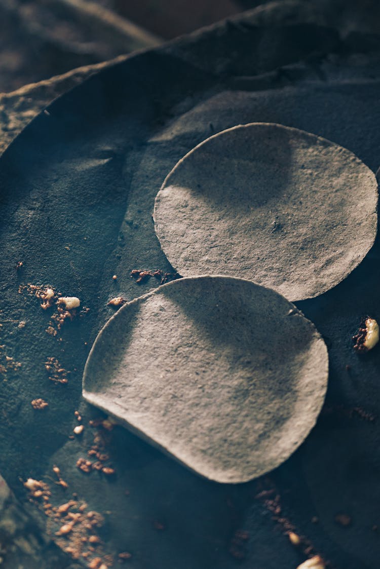 Round Tortilla On Black Pan For Frying