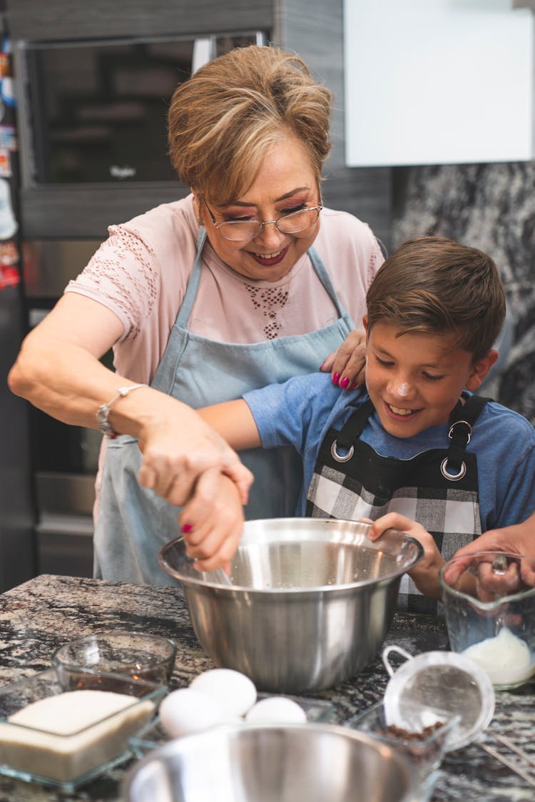 Grandma And Grandson Baking At The Kitchen