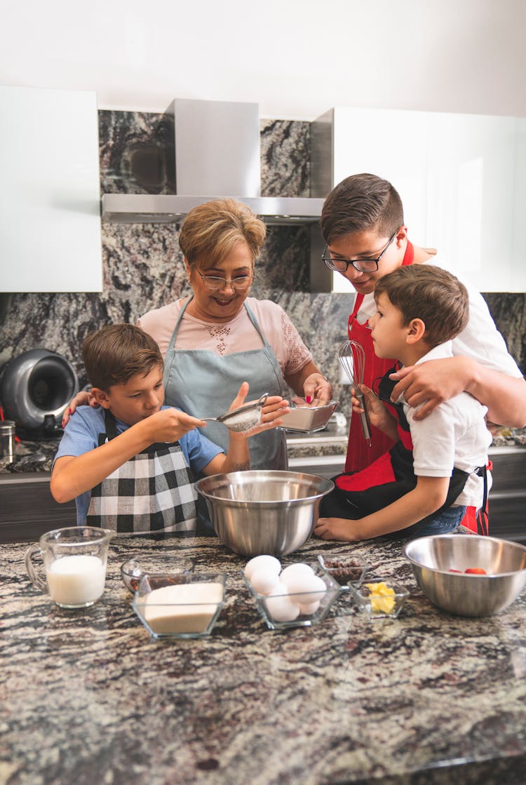 A Family Baking At The Kitchen