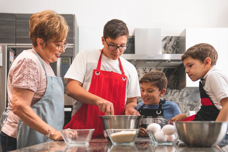 A Family Preparing Pancakes At The Kitchen