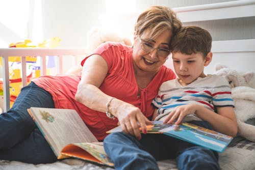 Woman and a Boy Reading a Book Together