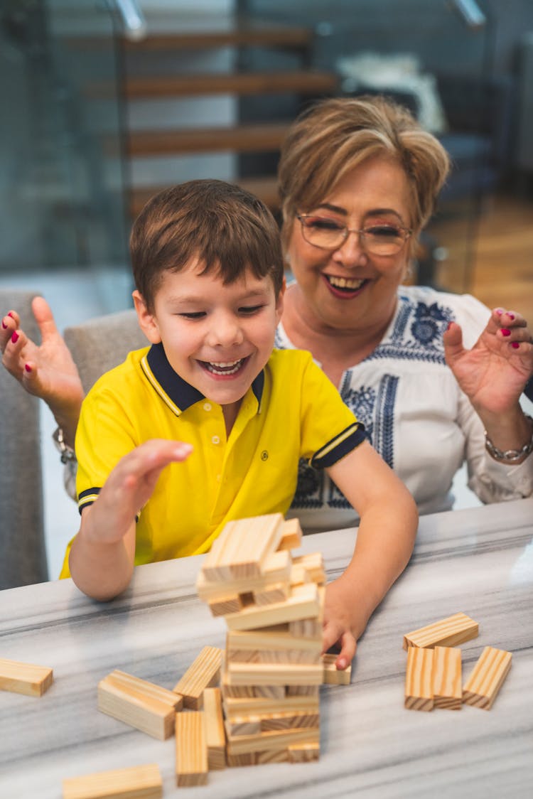 Woman And Child Playing With Wooden Blocks