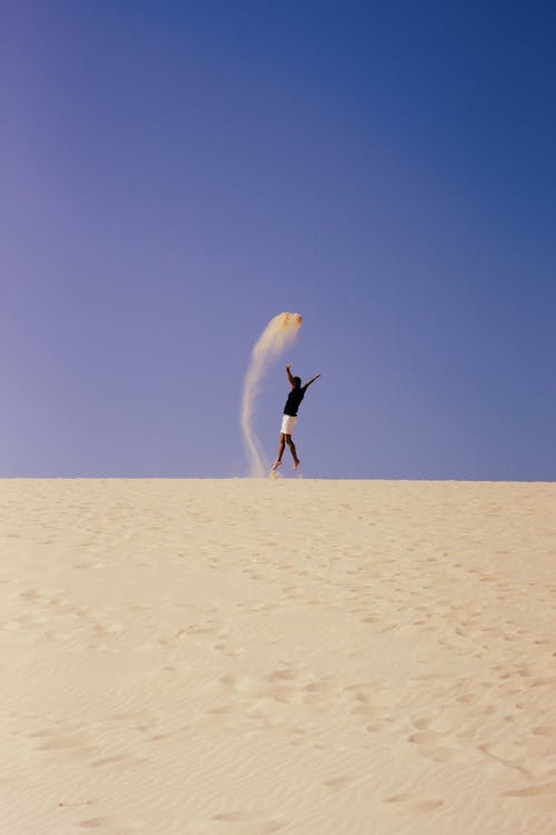 Man Jumping over Sand