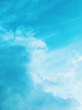 A vibrant blue sky with scattered white clouds, offering a serene atmosphere.