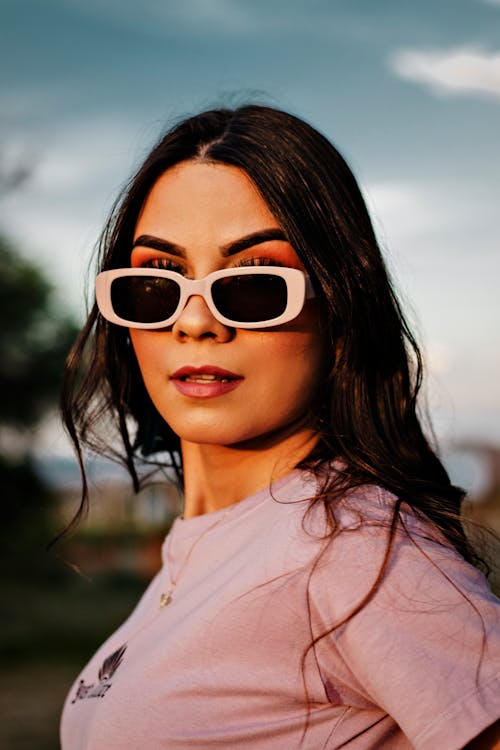 Woman Wearing Sunglasses Posing at the Camera 