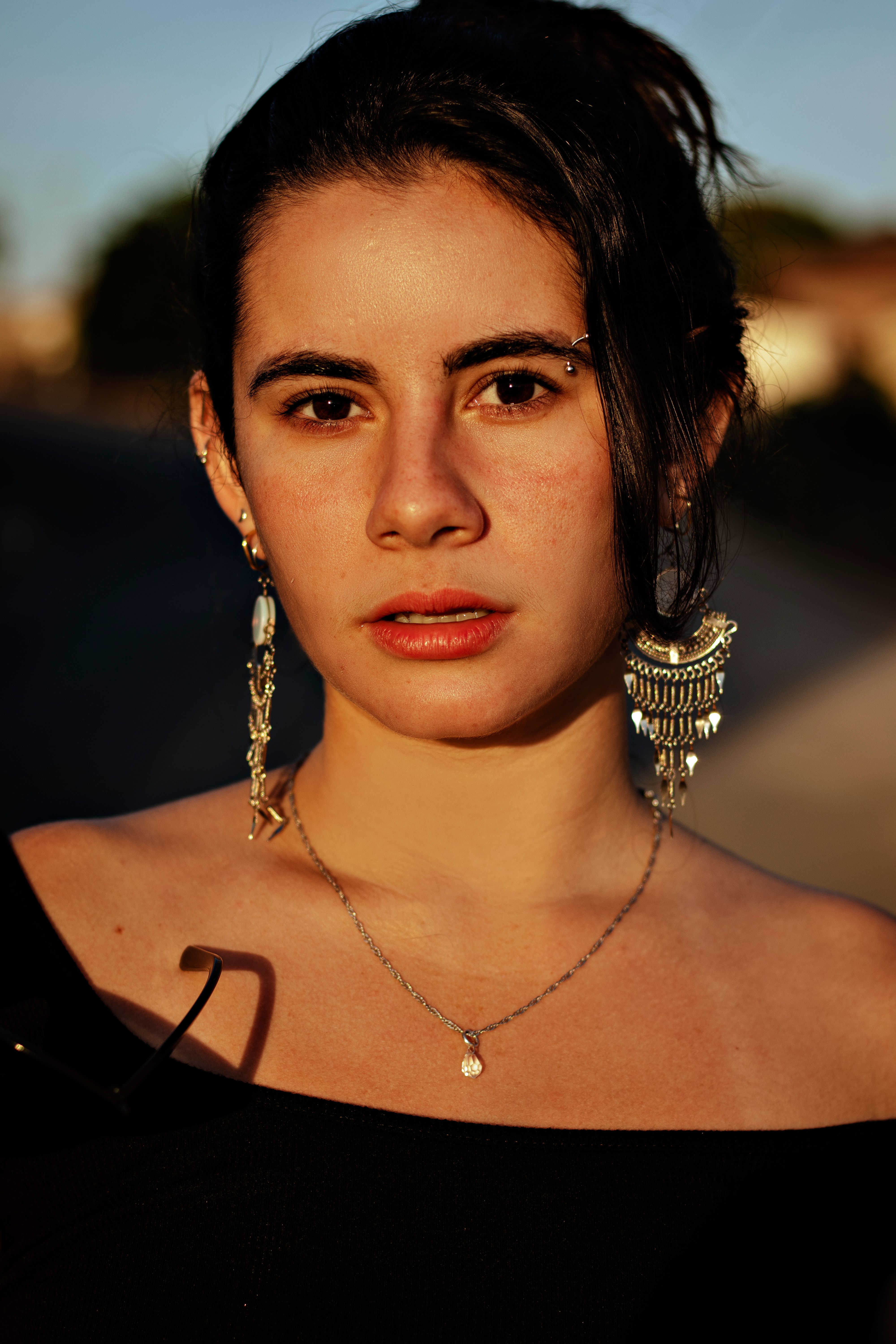 Woman in Black Shirt Wearing Silver Necklace · Free Stock Photo