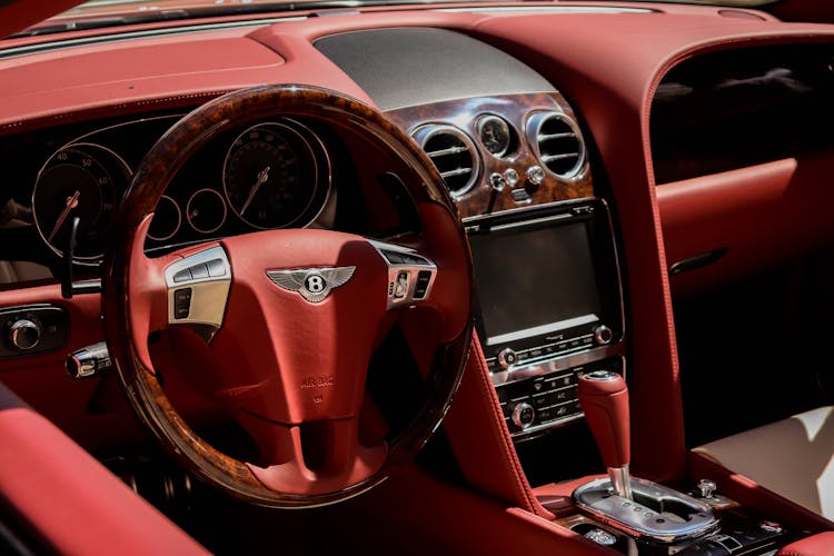 A Red Steering Wheel Inside The Luxury Car