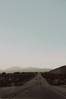 Scenic view of an open road in Palm Springs, capturing desert landscape under a clear sky.