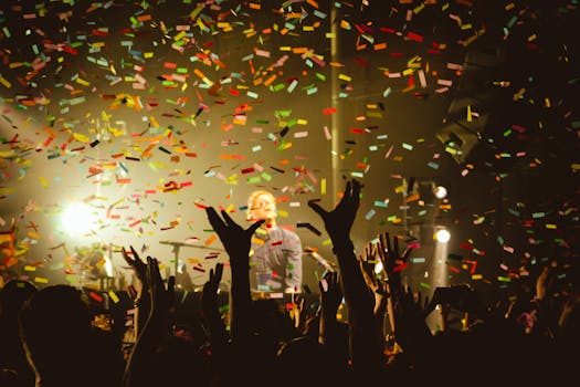 Vibrant concert scene with confetti falling over a cheering crowd in Portland.