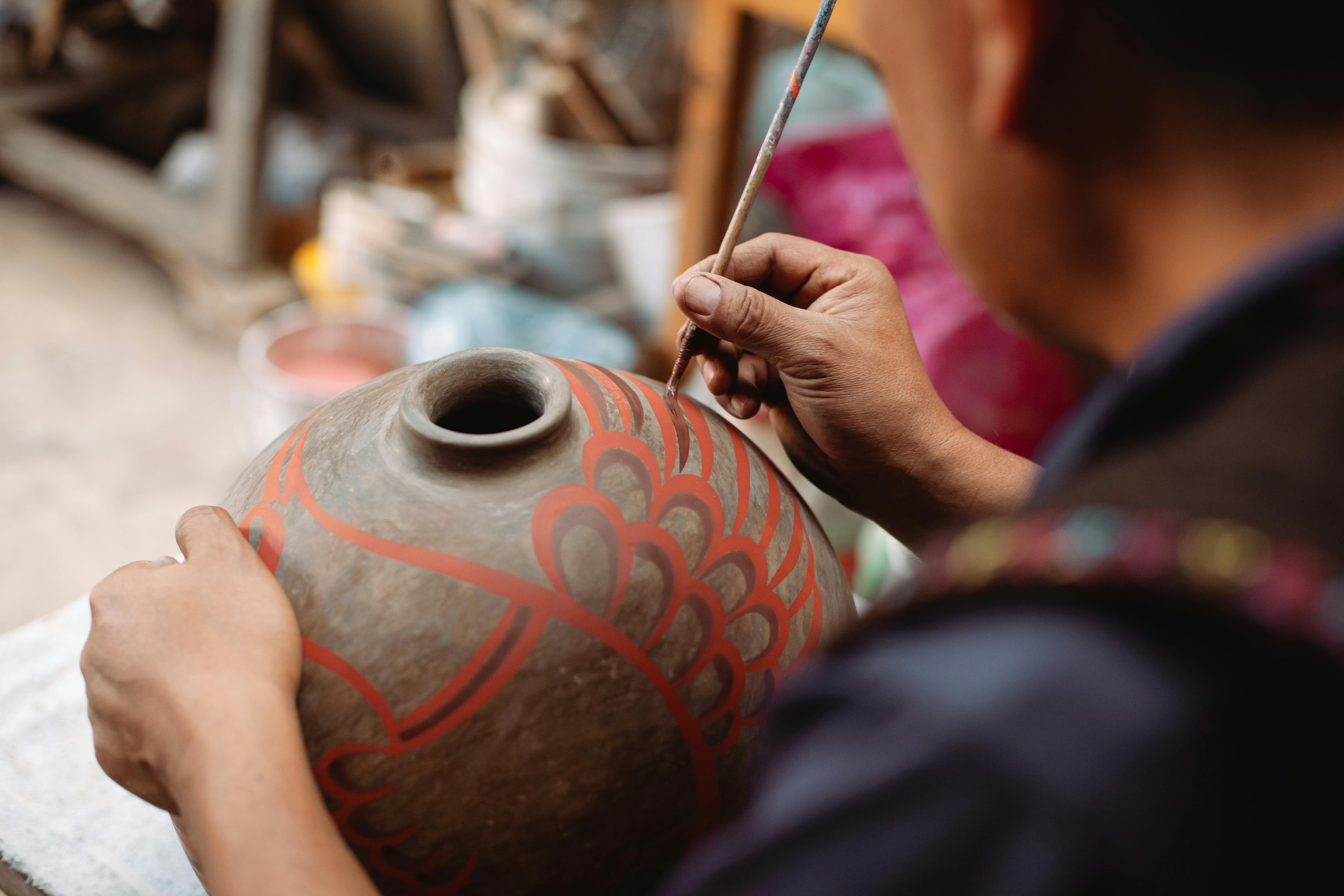 Person Pouring Water on Brown Clay Pot · Free Stock Photo