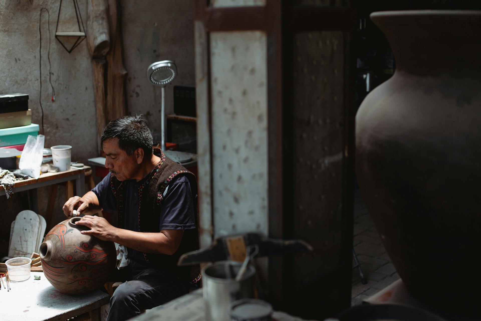 A Man Holding a Ceramic Jar