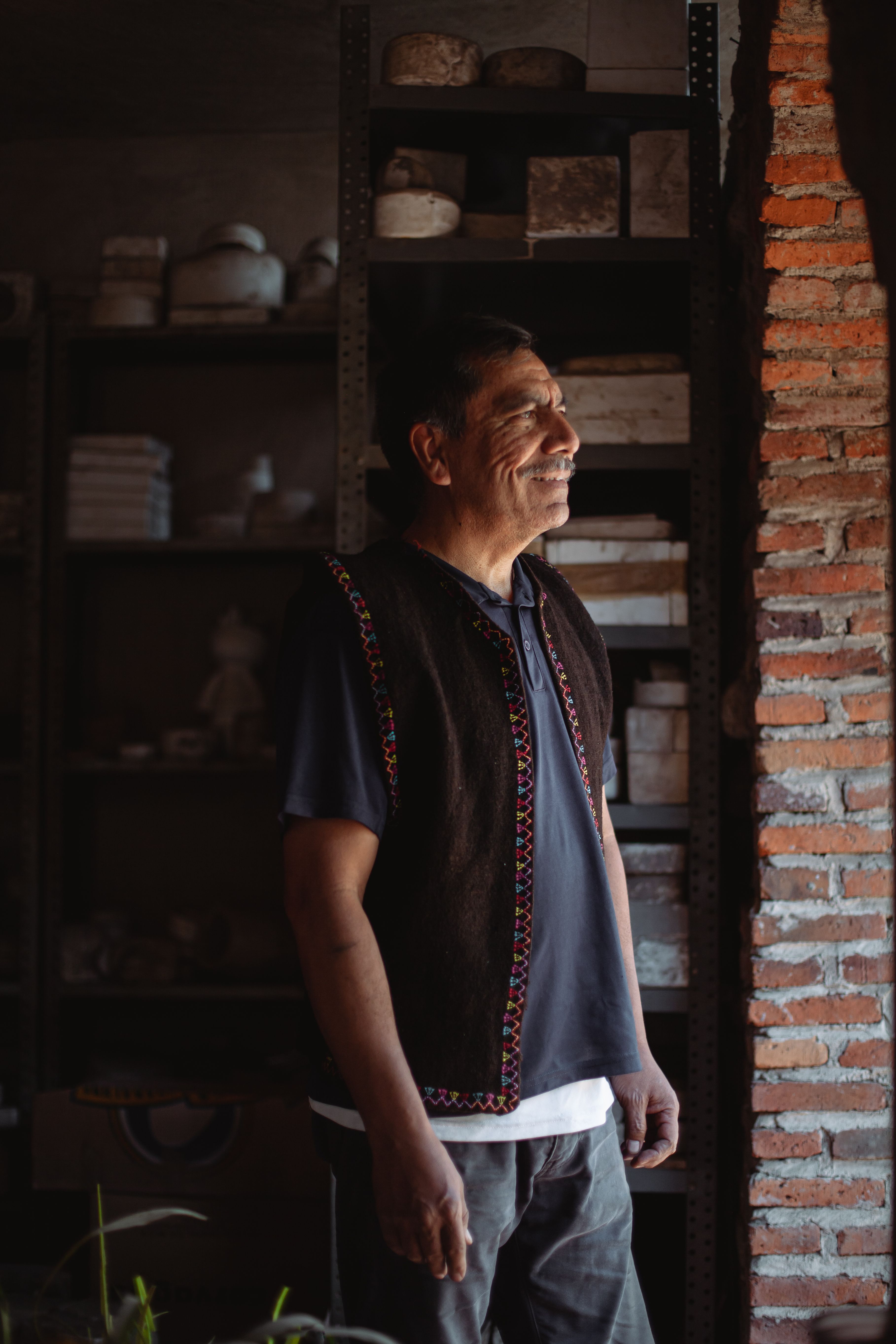 Portrait of a senior artisan in a rustic workshop, reflecting Mexican culture.