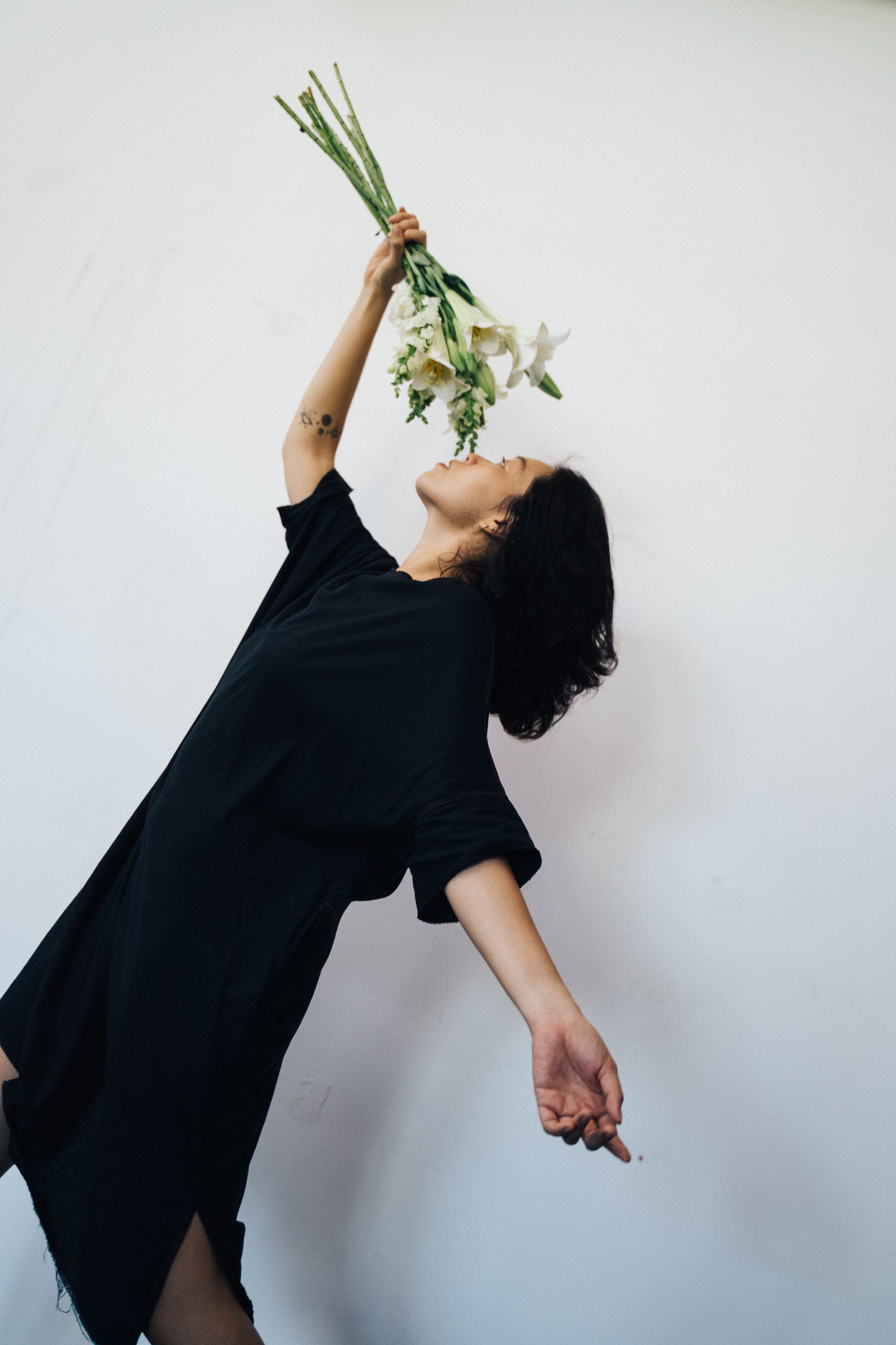 Woman in Black Dress Holding White Flower Bouquet · Free Stock Photo