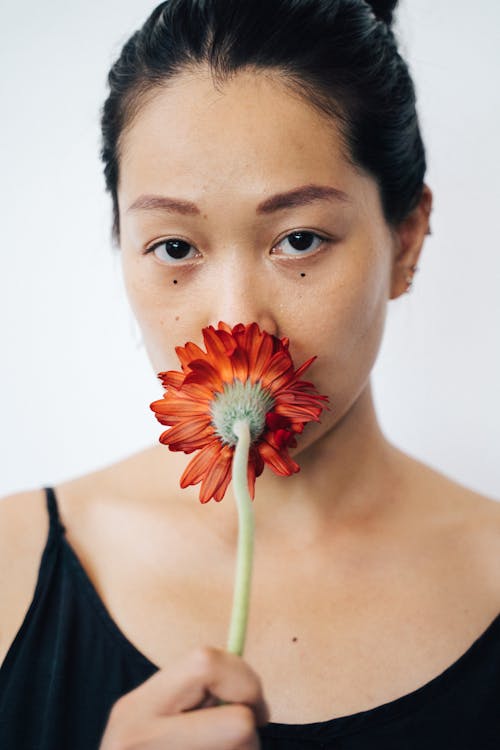 Woman Holding a Red Flower