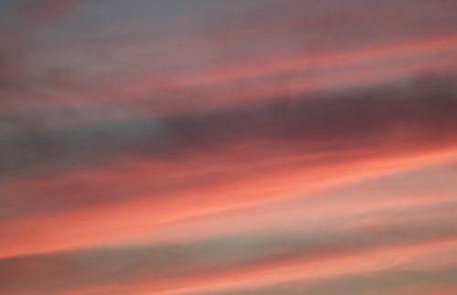 Free Beautiful sunset sky with pink and gray clouds creating a tranquil atmosphere. Stock Photo