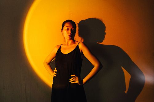 Free A creative portrait of a woman with dramatic lighting and shadows creating an artistic effect. Stock Photo