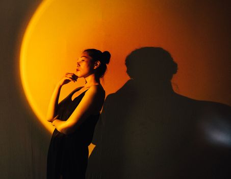 Man and Woman Kissing in Front of Orange Wall