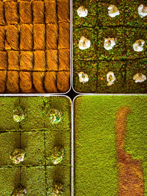 Free Top view of assorted Middle Eastern pastries in trays, showcasing vibrant colors and textures. Stock Photo