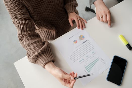 Close-up of colleagues reviewing charts and graphs during a meeting.