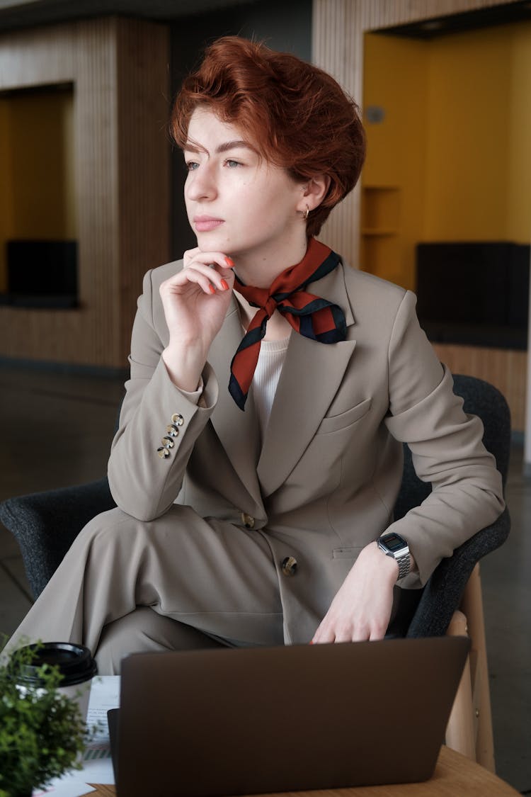 A Woman Wearing A Suit And A Neckerchief 