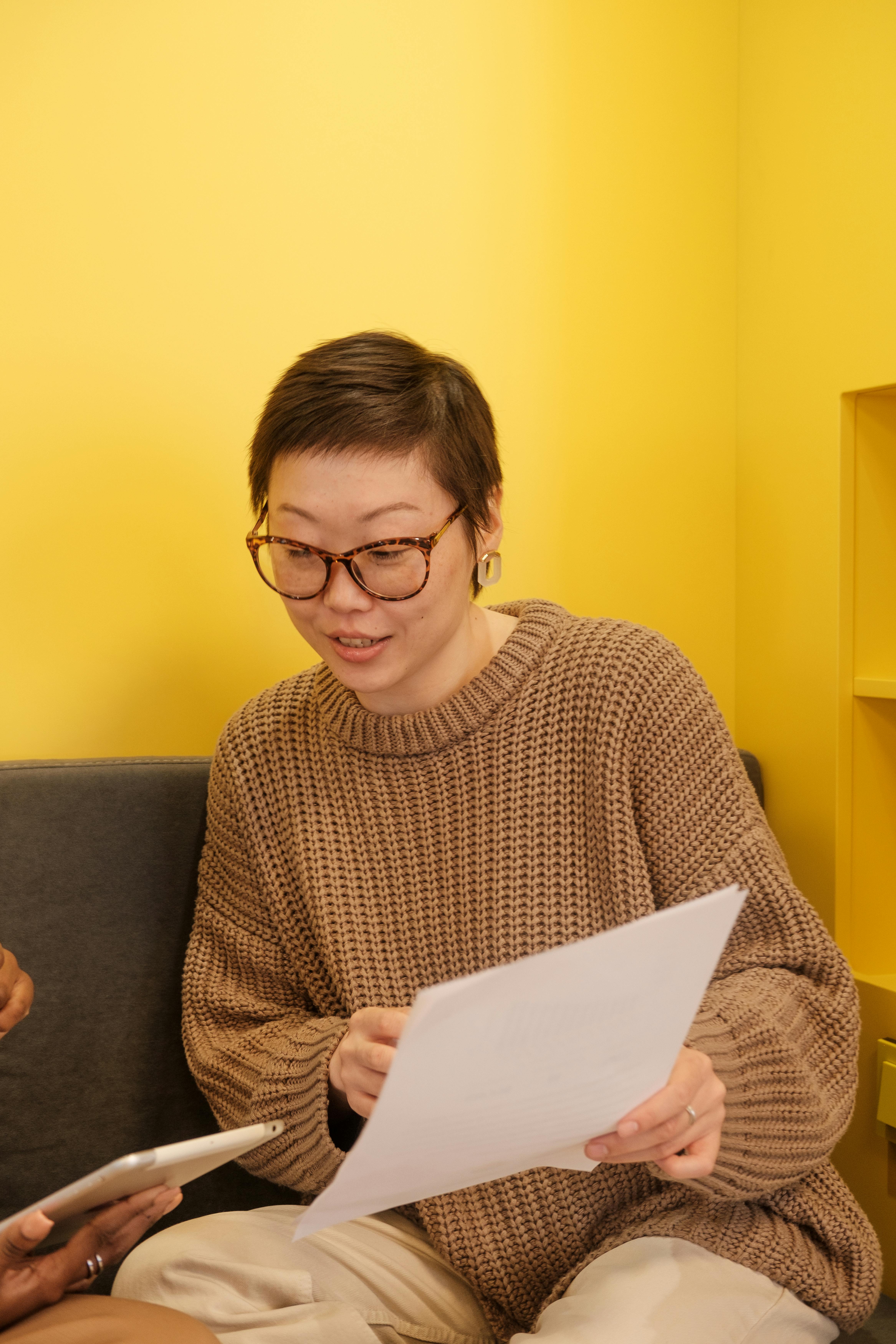 woman showing a document and talking