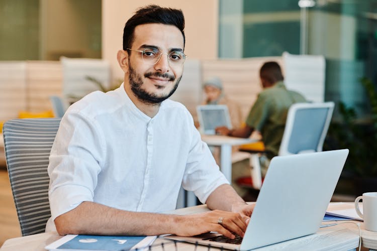 Bearded Man Wearing Eyeglasses While Using A Laptop