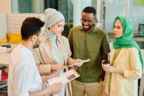 Free Men and Women Having a Discussion at the Office Stock Photo