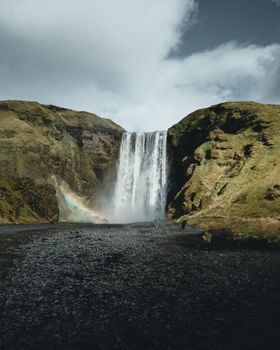 Majestic Skógafoss waterfall cascading in Iceland, showcasing nature's beauty and a vibrant rainbow
