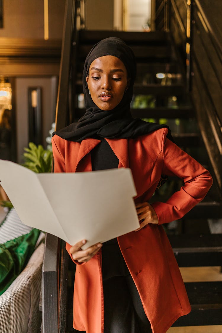 Woman In Black Hijab Holding A Folder