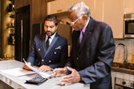 Man in Black Suit Jacket Using Macbook Pro