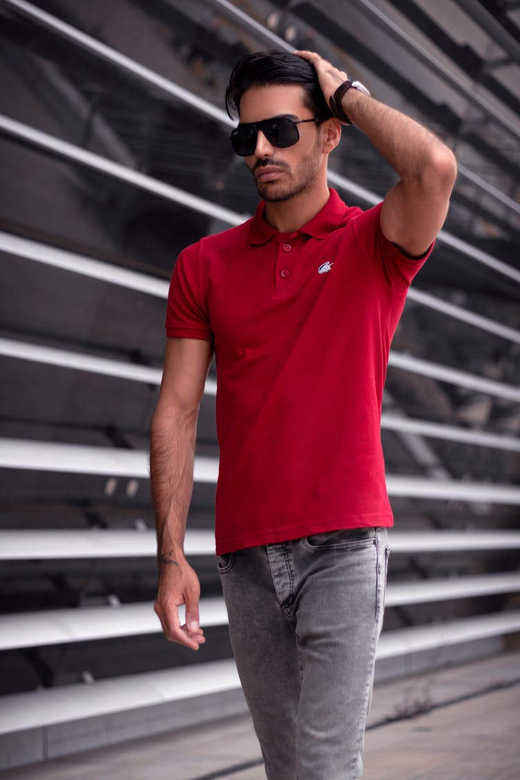 Man Wearing Red Polo Shirt Touching His Hair