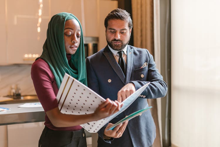 Man And Woman Looking At The Document