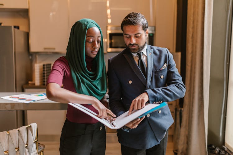 Man And Woman Holding A Folder