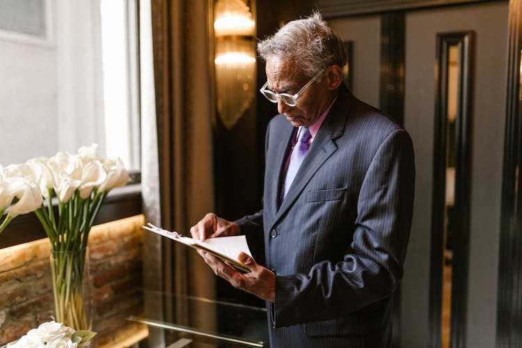 A Man Reading A Document